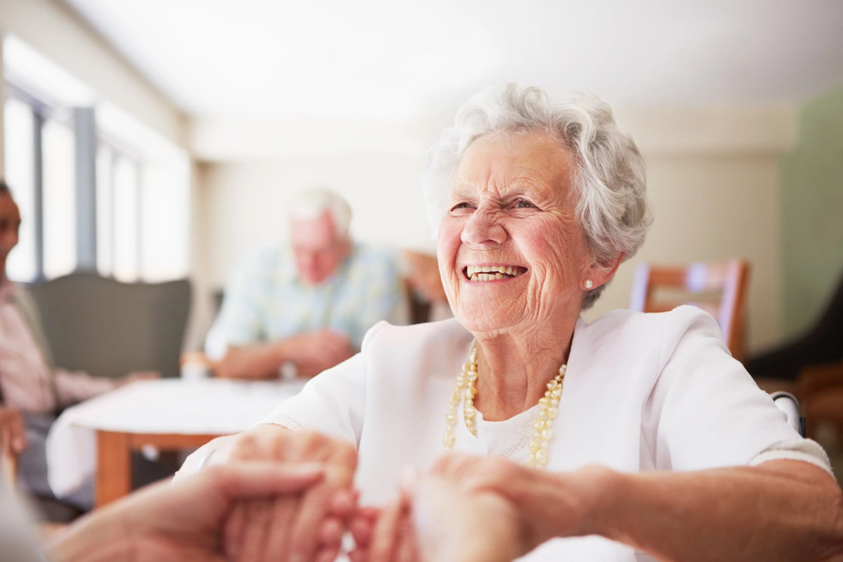 The Emotions of Caregiving What Families Feel emotions of caregiving: Caregiver holding hands with older woman in a warm, supportive moment