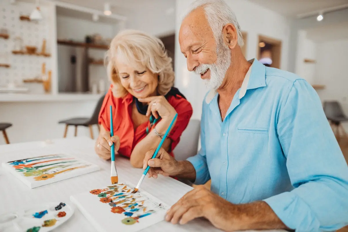 activities-to-combat-sundowning-memory-care-in-tacoma Senior couple painting together one of the activities to combat sundowning at The Village Senior Living in Tacoma, WA
